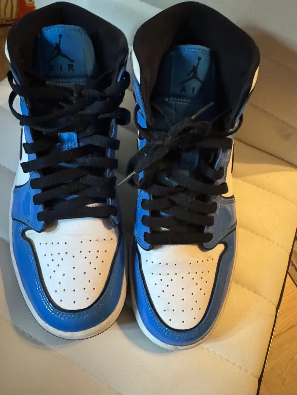 Men’s blue and white Jordan’s patent leather